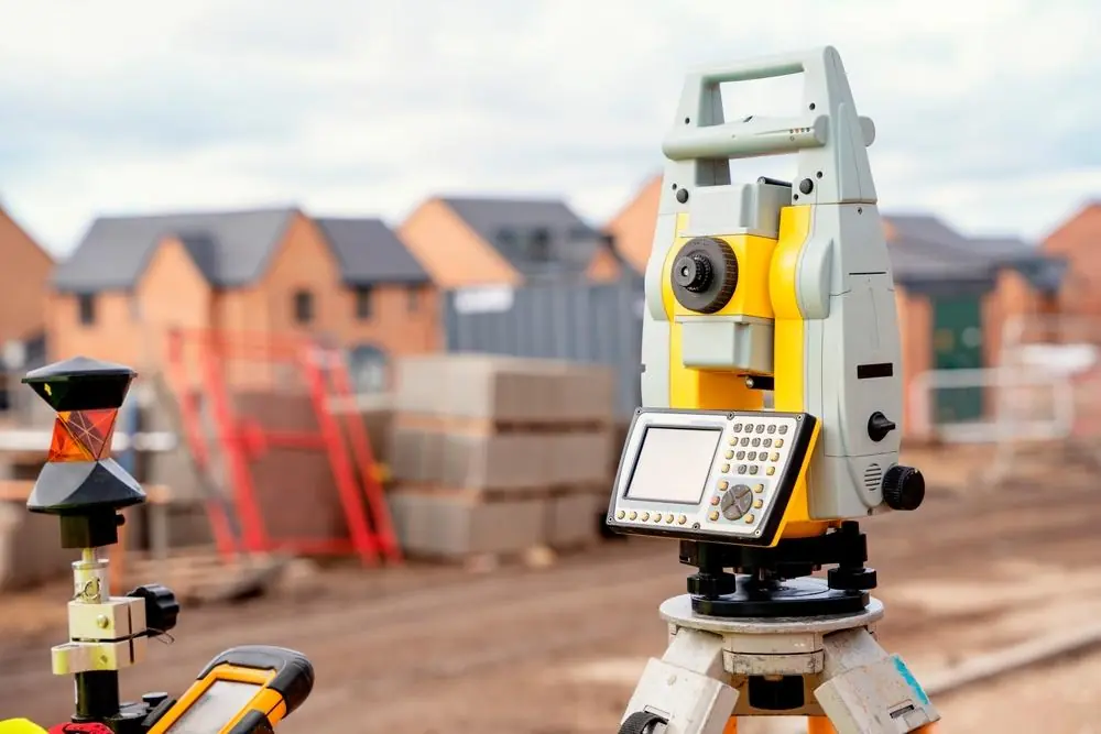 Surveying equipment used to plan grading near residential properties
